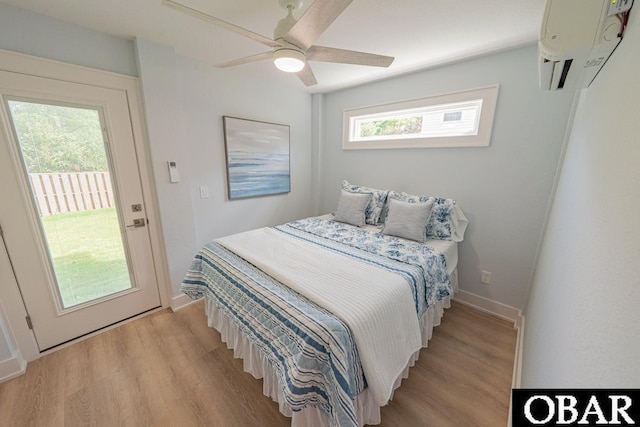 224 W Lost Colony Dr Lot 13, Nags Head, NC 27959 - bedroom featuring a wall mounted AC, access to outside, light wood finished floors, and a ceiling fan