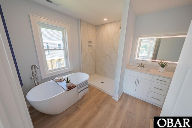224 W Lost Colony Dr Lot 13, Nags Head, NC 27959 - bathroom with a freestanding tub, wood finished floors, vanity, a walk in shower, and recessed lighting