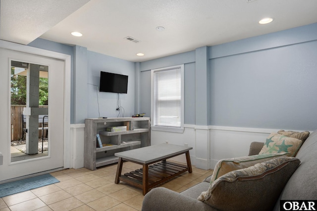 740 E Willet Ct Lot 54, Corolla, NC 27927 - living room featuring plenty of natural light, light tile patterned floors, and a wainscoted wall