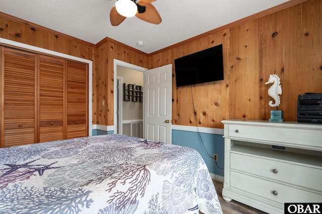 740 E Willet Ct Lot 54, Corolla, NC 27927 - bedroom with a ceiling fan, wood walls, ornamental molding, and a closet