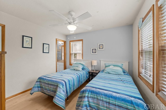 bedroom featuring a ceiling fan, baseboards, and wood finished floors