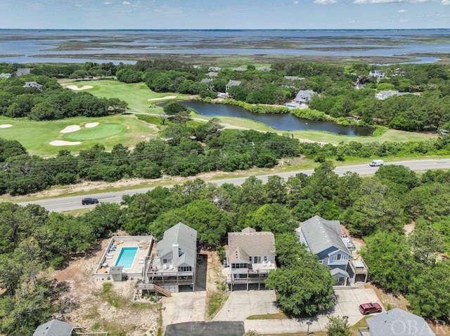 aerial view with golf course view and a water view