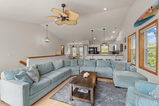 living room with visible vents, ceiling fan, light wood-style flooring, vaulted ceiling, and recessed lighting