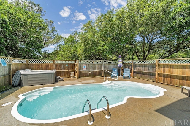 view of swimming pool featuring a fenced in pool, a patio area, a fenced backyard, and a jacuzzi