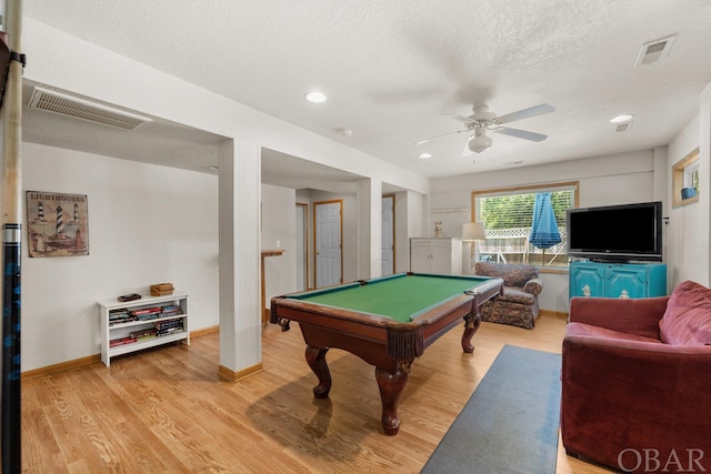 playroom with a textured ceiling, pool table, light wood-type flooring, and visible vents