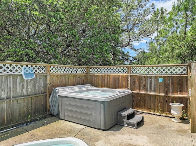 view of patio featuring a fenced backyard and a hot tub