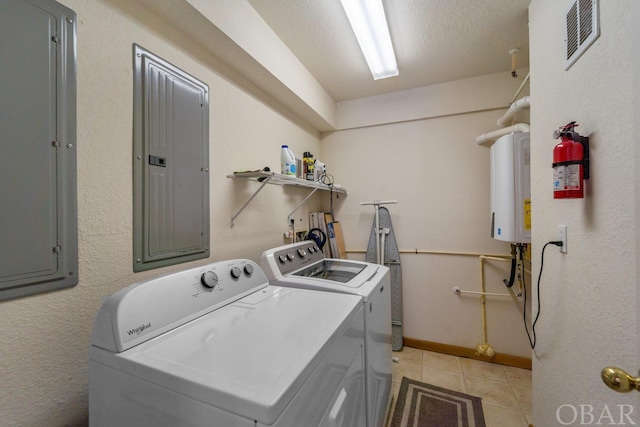 clothes washing area with washing machine and dryer, laundry area, visible vents, and electric panel