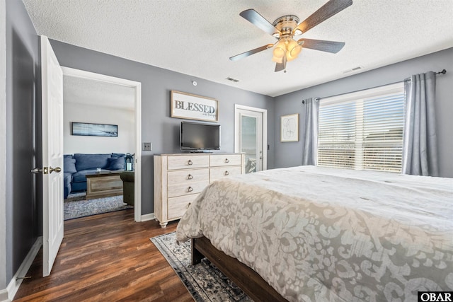 813 Pirates Way Unit 813, Manteo, NC 27954 - bedroom with dark wood-style flooring, a textured ceiling, baseboards, and a ceiling fan