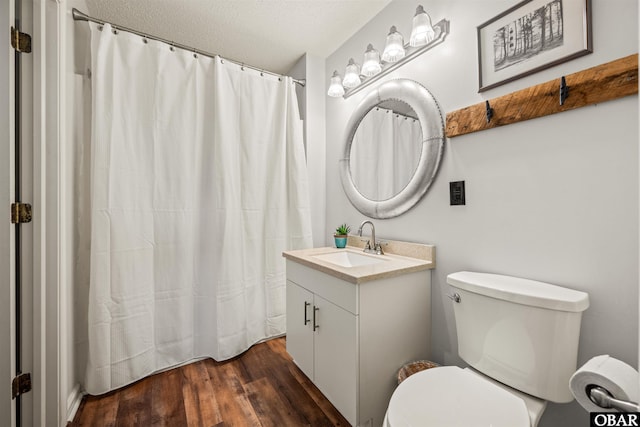 813 Pirates Way Unit 813, Manteo, NC 27954 - full bath featuring vanity, toilet, wood finished floors, curtained shower, and a textured ceiling