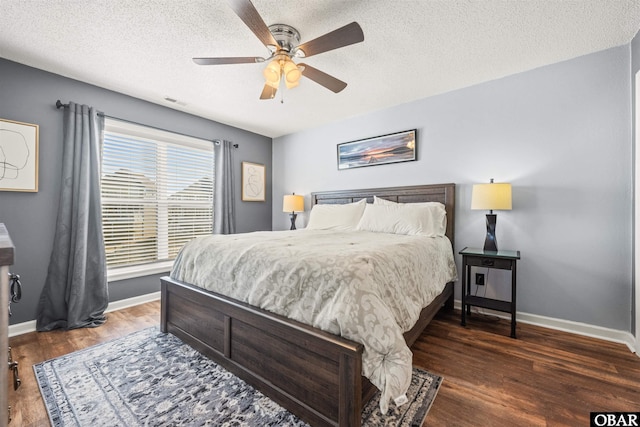 813 Pirates Way Unit 813, Manteo, NC 27954 - bedroom with baseboards, wood finished floors, a textured ceiling, and a ceiling fan