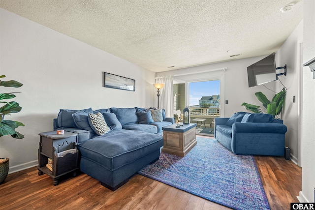 813 Pirates Way Unit 813, Manteo, NC 27954 - living area featuring wood finished floors, a textured ceiling, and baseboards