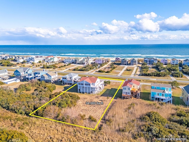 birds eye view of property with a water view and a residential view