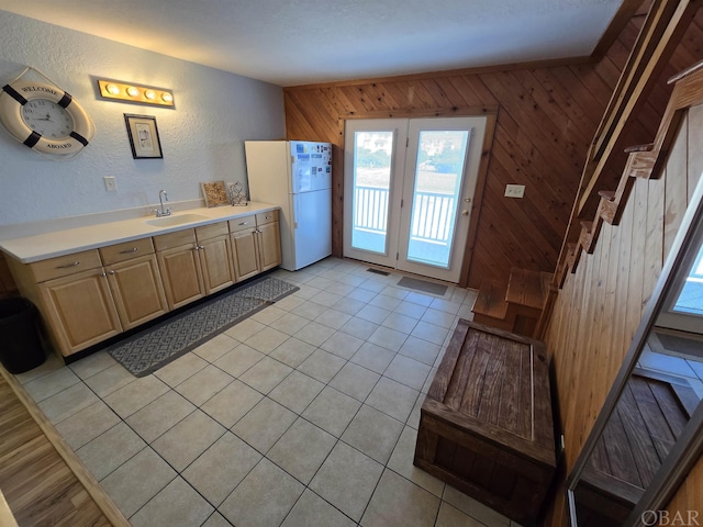 bathroom with visible vents, a textured wall, tile patterned floors, vanity, and wood walls