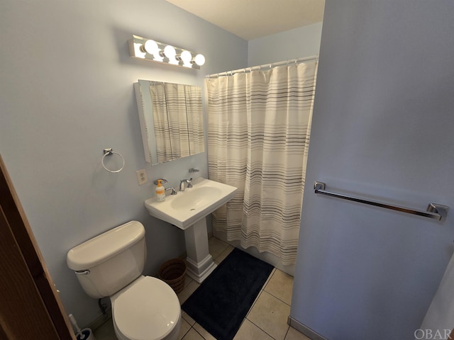 full bath featuring a shower with shower curtain, toilet, and tile patterned floors