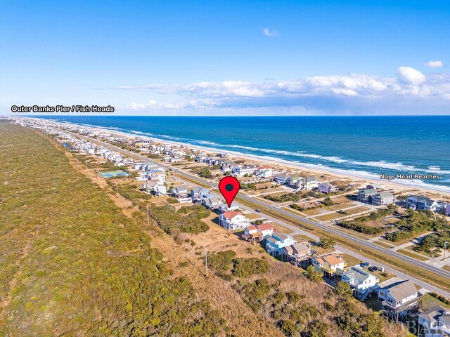 birds eye view of property with a view of the beach and a water view