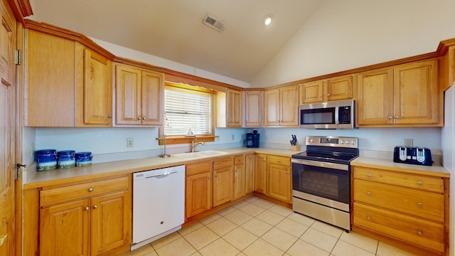 46065 Cape Point Way Lot 58, Buxton, NC 27920 - kitchen with appliances with stainless steel finishes, a sink, light tile patterned floors, light countertops, and high vaulted ceiling