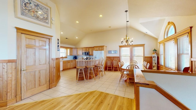 46065 Cape Point Way Lot 58, Buxton, NC 27920 - dining area with wainscoting, plenty of natural light, vaulted ceiling, a chandelier, and light wood finished floors