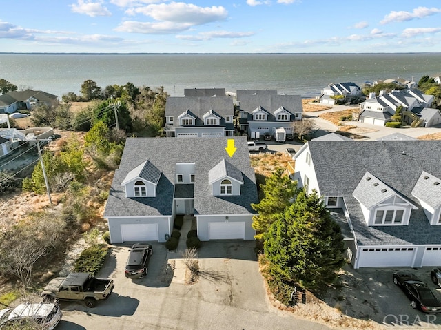 bird's eye view featuring a water view and a residential view