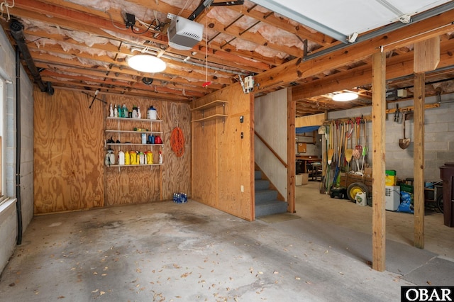 basement with stairway and a garage