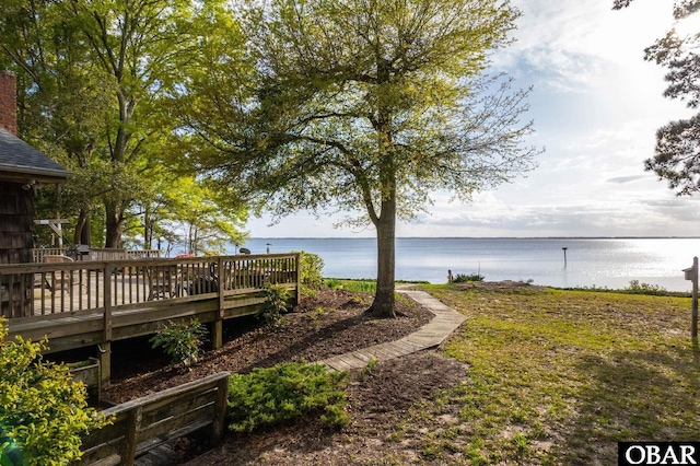 view of yard with a deck with water view