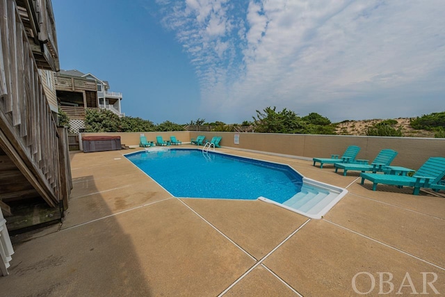 view of pool featuring a patio, a fenced backyard, a fenced in pool, and a hot tub