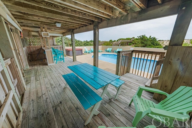 wooden deck with a hot tub and a fenced in pool