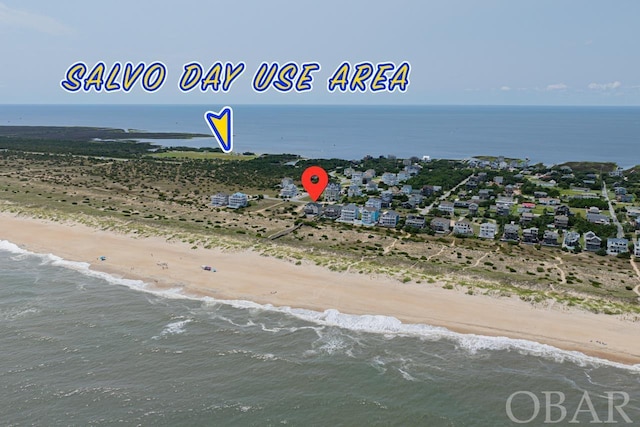 birds eye view of property with a water view and a view of the beach