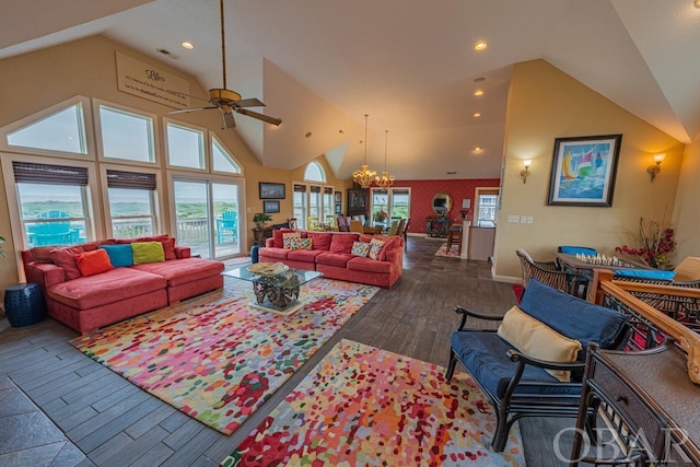 living room with dark wood-type flooring, visible vents, a healthy amount of sunlight, and high vaulted ceiling