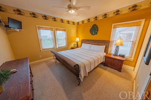 bedroom featuring light carpet, ceiling fan, and baseboards