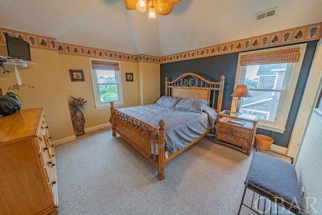 bedroom with lofted ceiling, light colored carpet, visible vents, ceiling fan, and baseboards