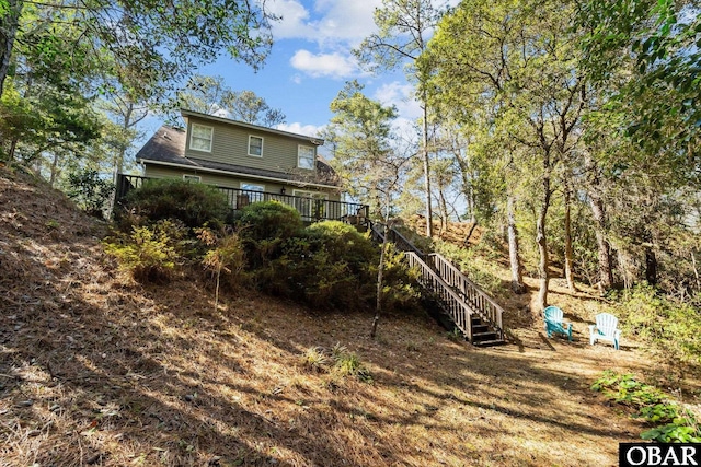 back of house featuring a wooden deck and stairs