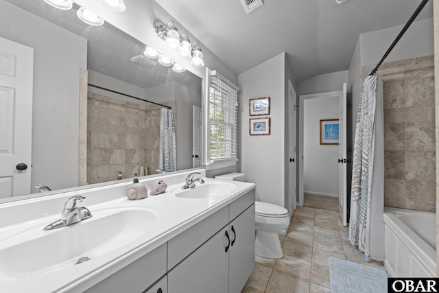 bathroom featuring a sink, visible vents, toilet, and double vanity