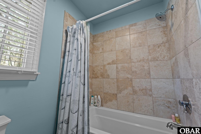 bathroom with shower / bathtub combination with curtain