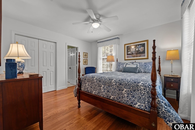 bedroom with a closet, wood finished floors, and a ceiling fan