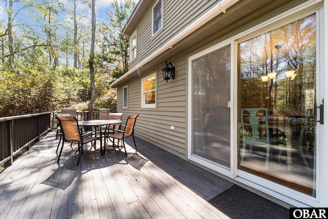 wooden terrace with outdoor dining space