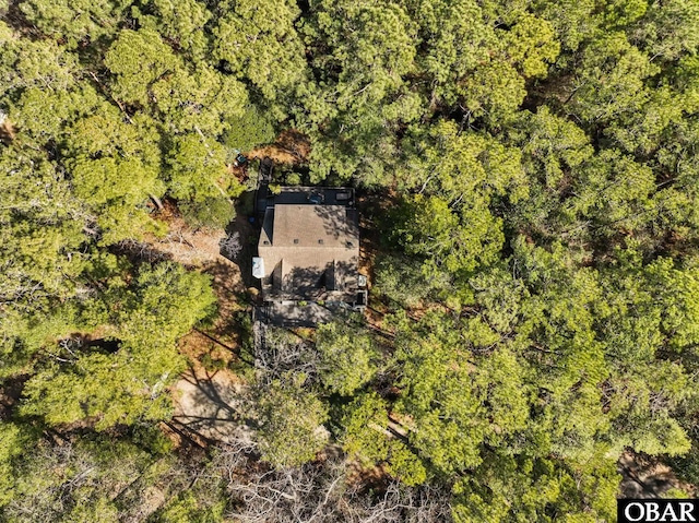 birds eye view of property with a view of trees