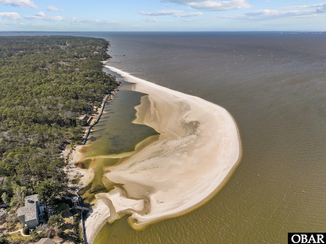 drone / aerial view featuring a beach view and a water view