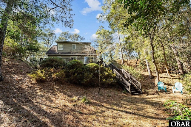 back of property featuring stairway and a wooden deck