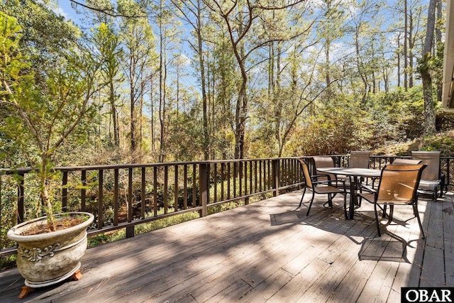 wooden terrace featuring outdoor dining area