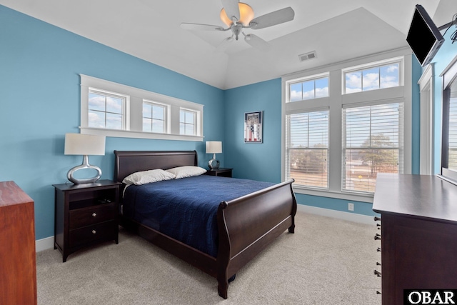 bedroom with baseboards, multiple windows, and light colored carpet