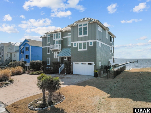2916 Bay Drive Lots 17&18, Kill Devil Hills, NC 27948 - view of front of property with concrete driveway, a water view, an attached garage, a standing seam roof, and metal roof
