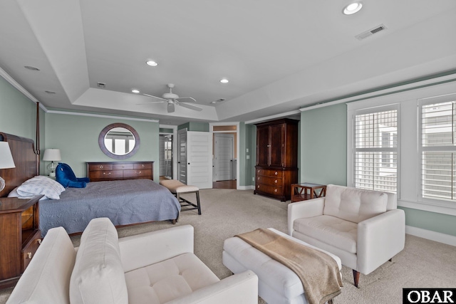 bedroom with baseboards, multiple windows, a raised ceiling, and light colored carpet