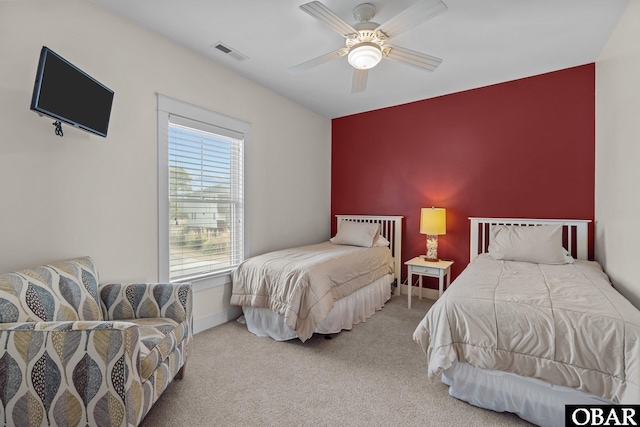 carpeted bedroom featuring ceiling fan and visible vents