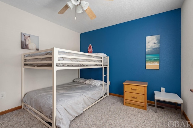 carpeted bedroom with baseboards and a ceiling fan