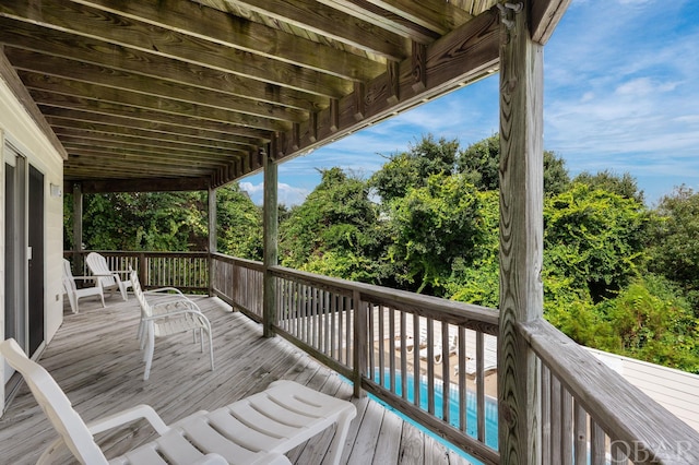 wooden terrace featuring a pool