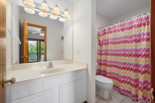 full bath featuring a shower with shower curtain, toilet, ceiling fan, tile patterned flooring, and vanity