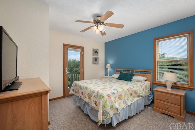 bedroom featuring ceiling fan, a textured ceiling, light colored carpet, baseboards, and access to exterior