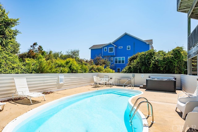 view of pool featuring a patio, a fenced backyard, a fenced in pool, and a hot tub