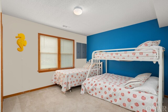 bedroom featuring carpet floors, electric panel, a textured ceiling, and baseboards