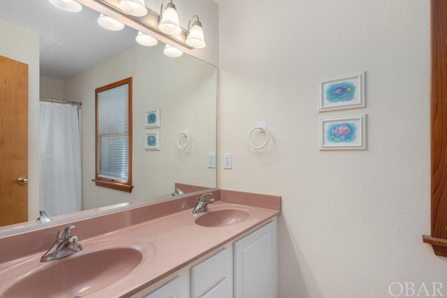 full bath featuring double vanity and a sink